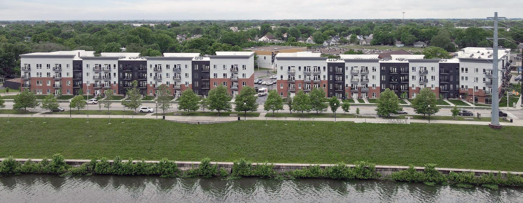 a row of buildings by a river