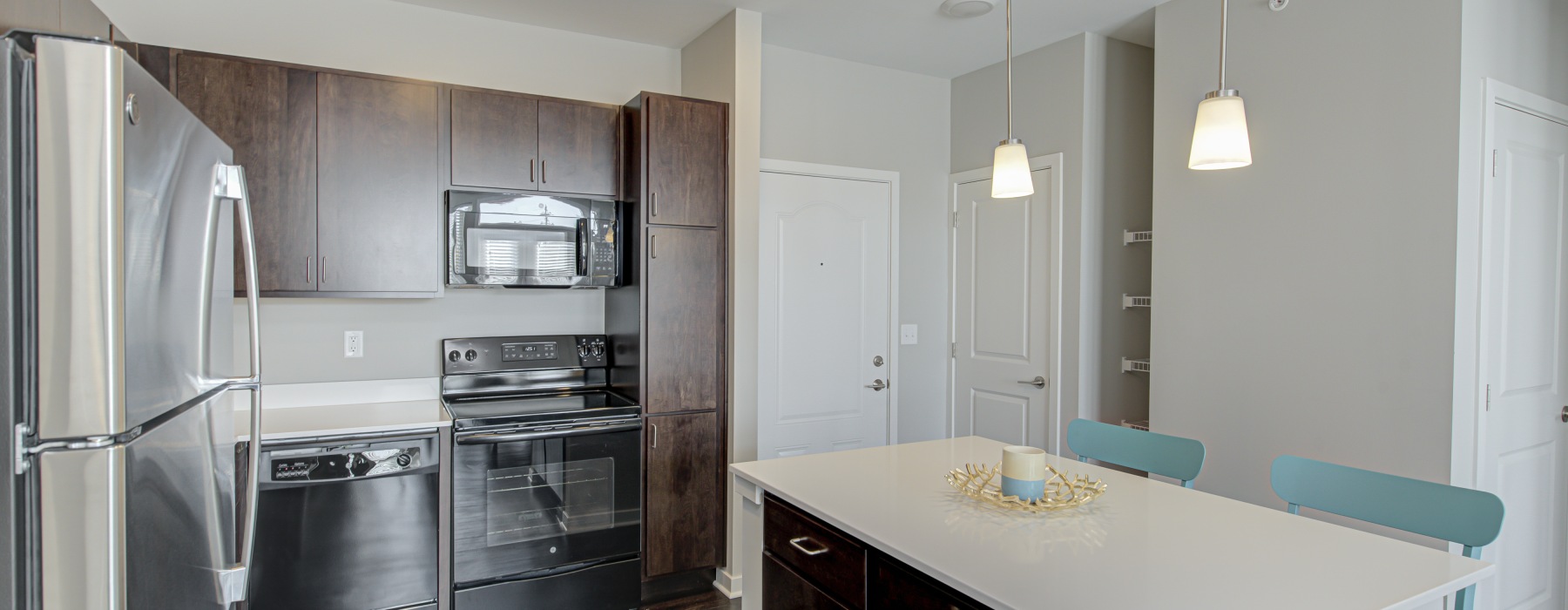 Apartment with brown cabinets and stainless steel appliances